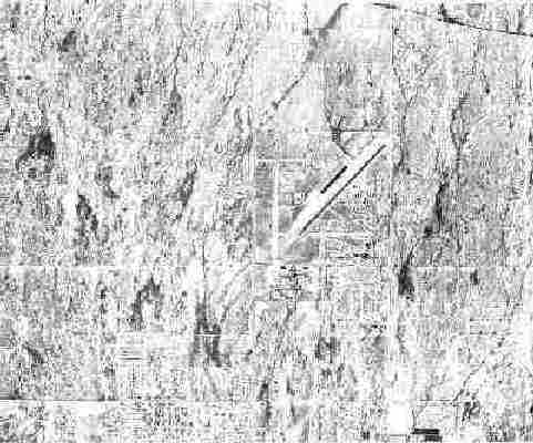 High‑contrast aerial view of a large, sparsely detailed landscape with a diagonal runway and surrounding grid-like roads faintly visible.