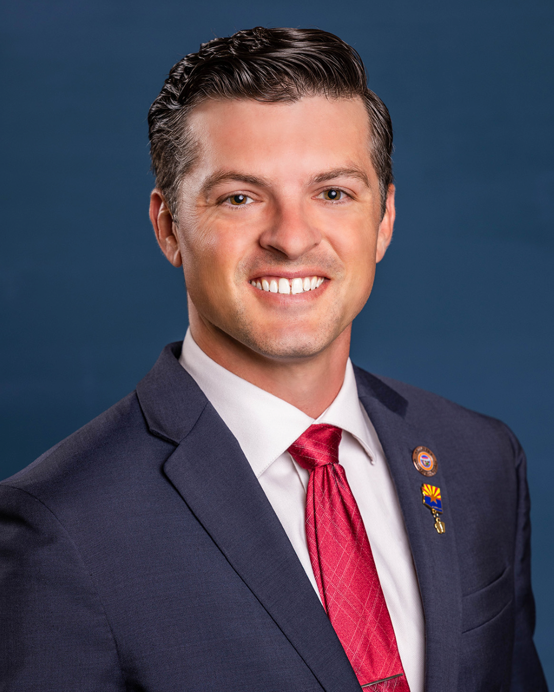 A portrait of Representative Cody Reim smiling in front of a plain background.