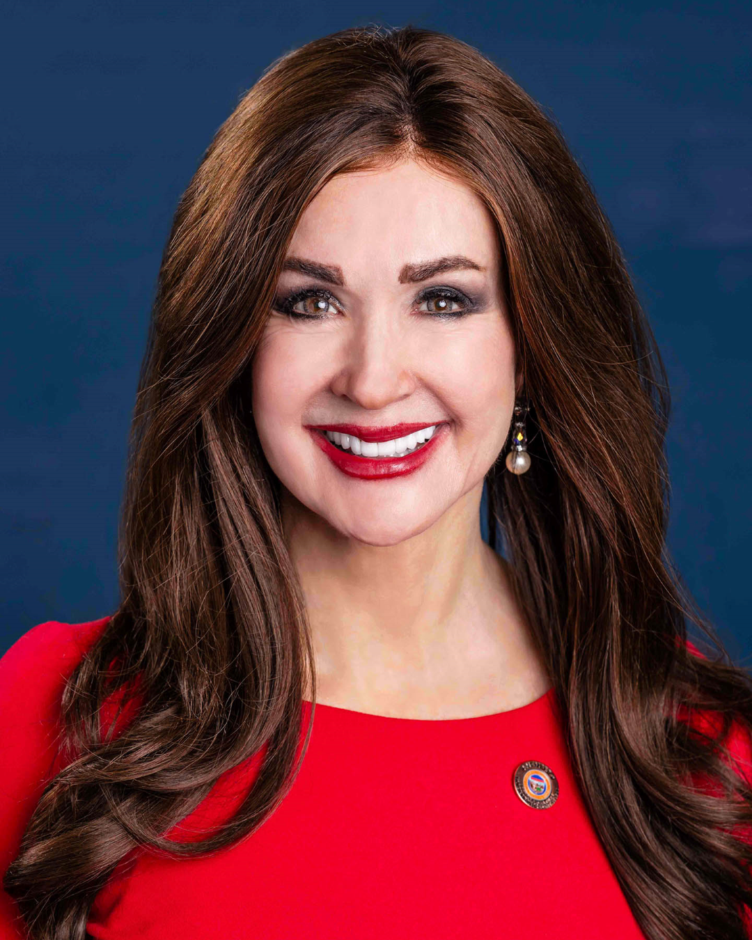 A portrait of Representative Pamela Carter smiling in front of a plain background.
