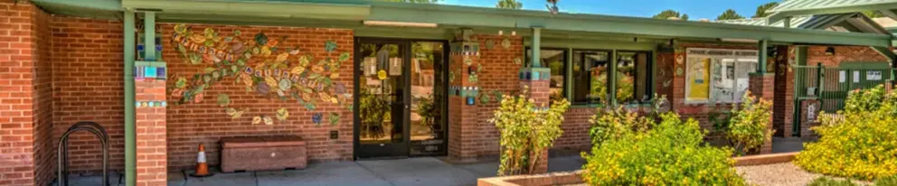 view of brick front of Pauite Neighborhood Center offices with decorative tile decor
