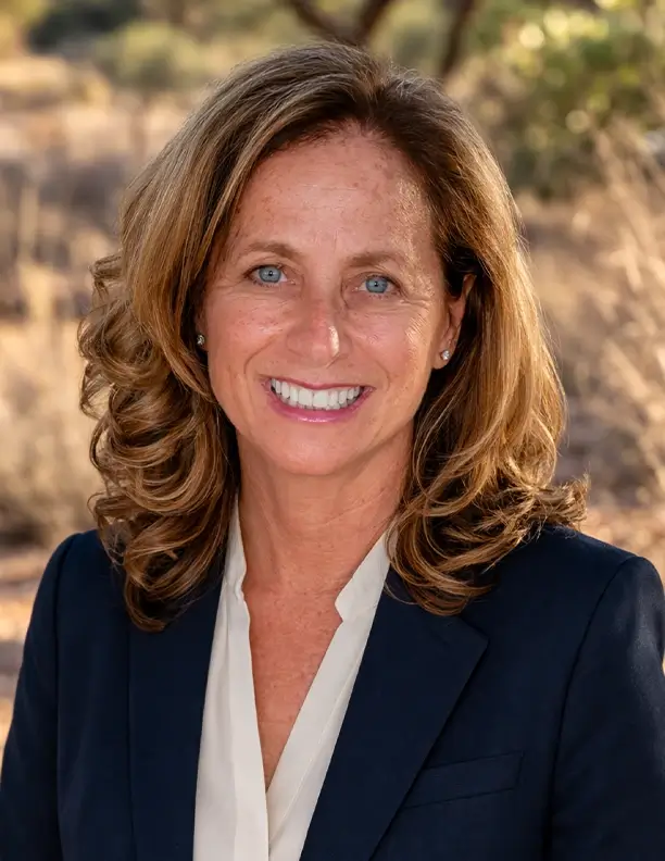 A portrait of councilwoman Solange Whitehead smiling in front of a plain background.