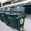 Row of green stadium seats with a City of Scottsdale emblem on the end armrest and numbered seat backs.