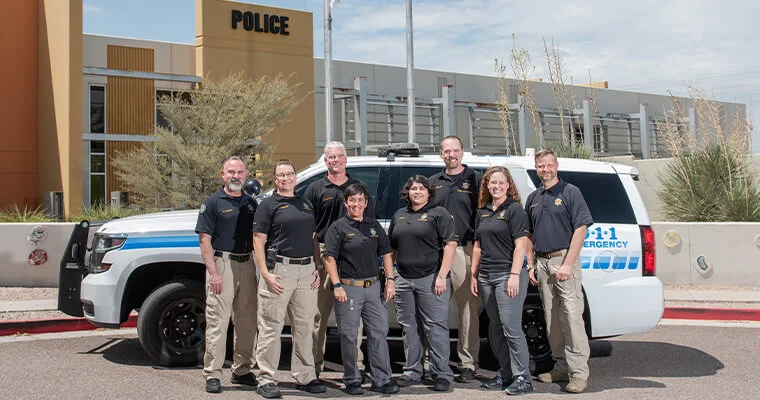 crime prevention unit posing in front of police car